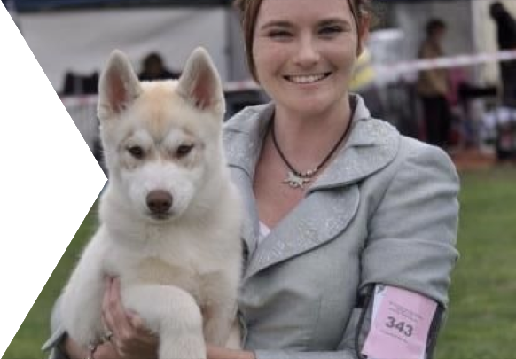 Woman holding a white dog